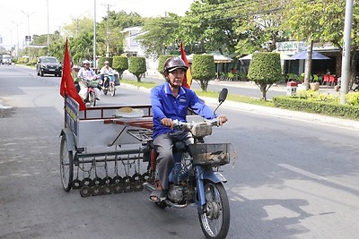 Người đàn ông đội nắng, dầm mưa hút đinh trên đường